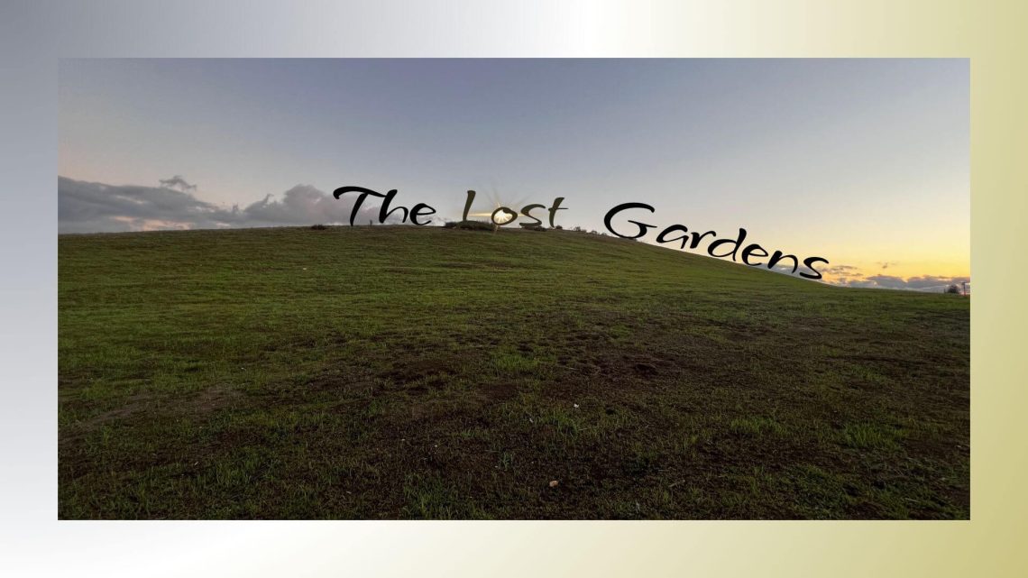 A green hillside under a soft evening sky, with the sun glowing through the words “The Lost Gardens” placed across the hilltop.
