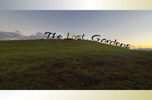 A green hillside under a soft evening sky, with the sun glowing through the words “The Lost Gardens” placed across the hilltop.