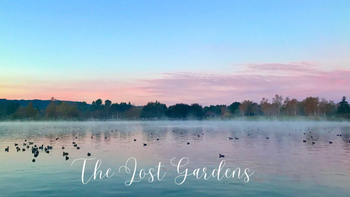 the lost gardens with lake and trees in the background