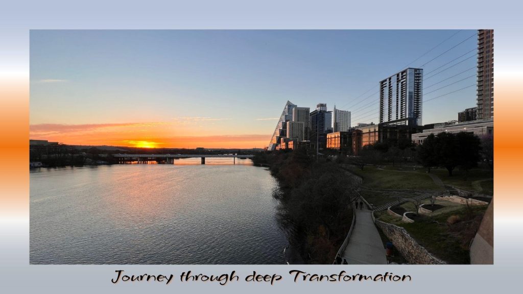 “City skyline at sunset with golden light reflecting on the water, symbolizing the journey through deep transformation.”