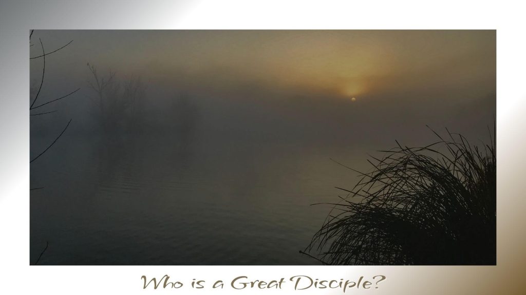 The sun rises faintly through a heavy mist over calm waters, with silhouetted trees and tall grasses framing the scene in quiet reverence.