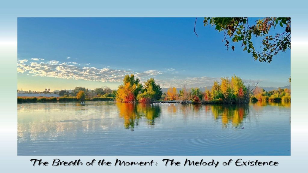 “Peaceful lake reflecting autumn-colored trees under a bright blue sky with clouds, symbolizing stillness and the melody of existence.”